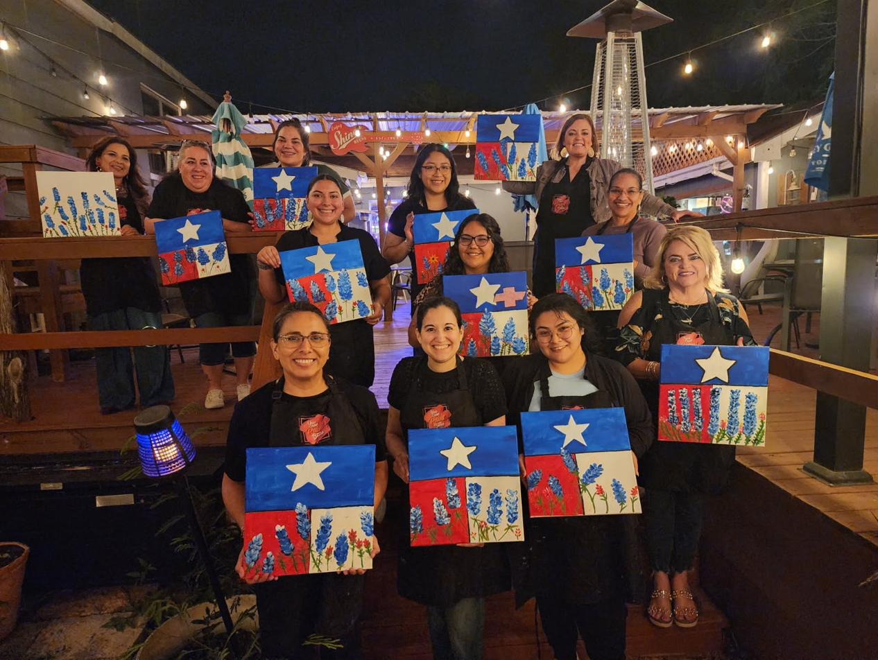 Guests holding Texas flag bluebonnet paintings
